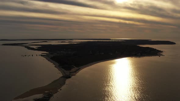 an aerial view over the eastern end of Orient Point, Long Island at sunset. The drone camera dolly i