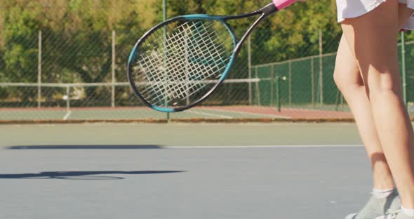 Video of midsection of diverse female tennis players holding rackets and clapping hands