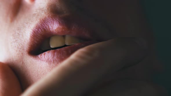 Man Holds Palm on Chin Under Lip and Moves Opened Mouth