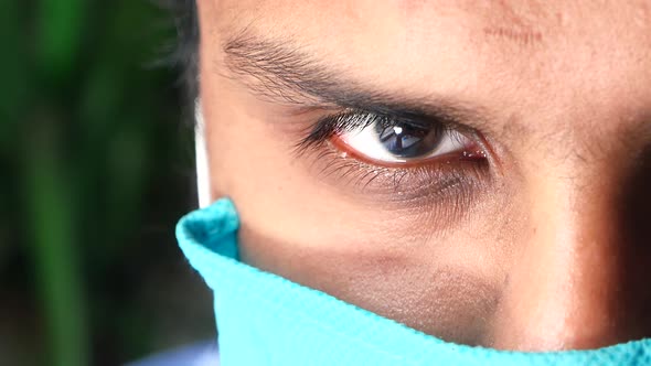 Close Up of Man with Protective Face Mask Looking at Camera 