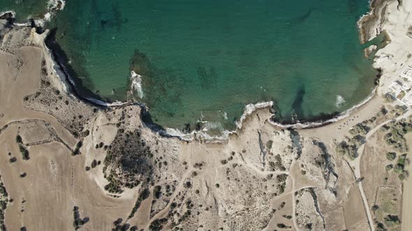 Sleepy beach town overlooks rolling waves and crystal-clear waters on the Mediterranean. Summertime