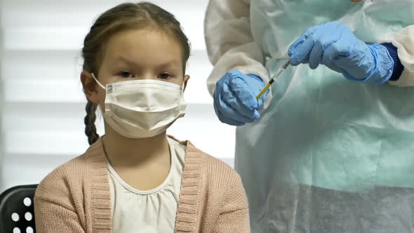 Close Up of Professional Healthcare Specialist Female Nurse in Protective Uniform and Medical Mask