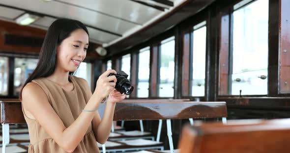 Traveler taking photo with digital camera on ferry in Hong Kong 