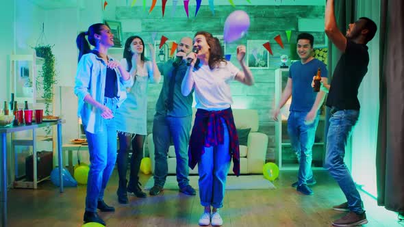 Cheerful Young Woman Singing for Her Friends