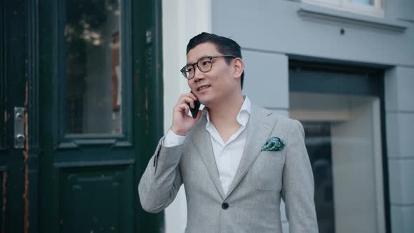 Korean Businessman Ending Successful Phone Call