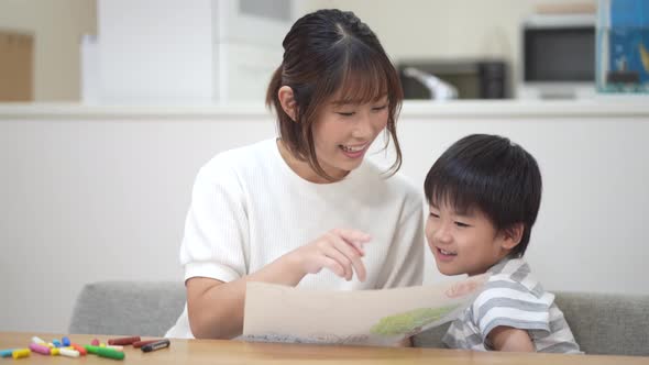 Parent and child looking at the picture they drew