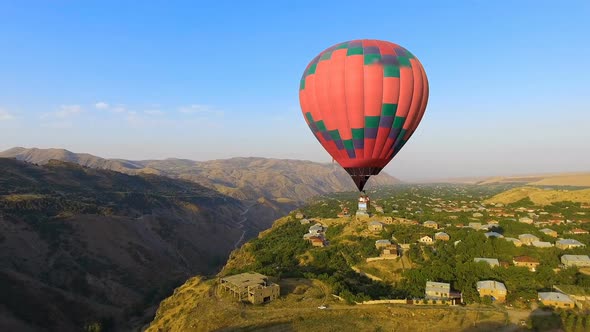 Aerial View of Beautiful Hot Air Balloon Flying Over Mountain Village, Armenia