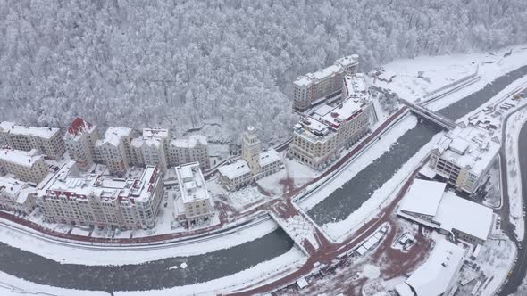 Aerial Rotation View Cinematic Winter City Ski Resort Surrounded By Alpine Mountain Scenery