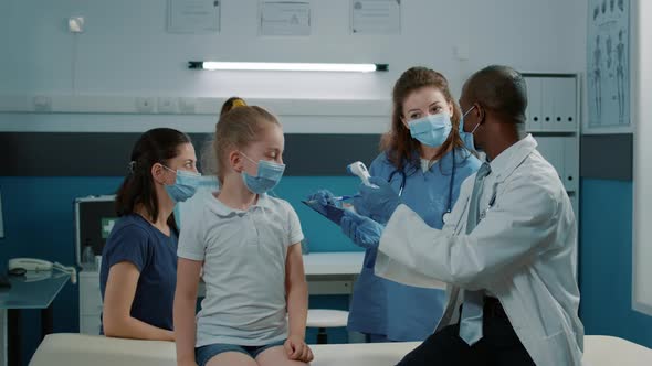 Doctor Checking for Coronavirus Symptoms with Thermometer