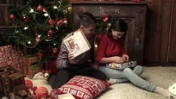Young Couple Packing the Presents at Home