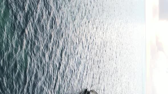 Vertical Video Boats in the Ocean Near the Coast of Zanzibar Tanzania Aerial View