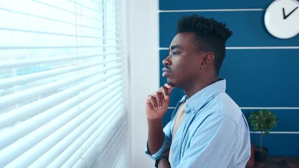 Young Thoughtful African American Businessman Entrepreneur Looking Out Window