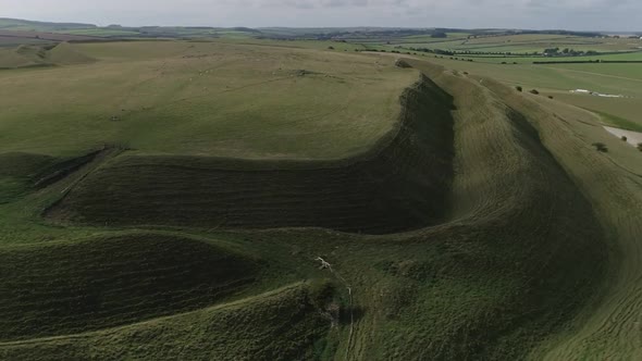 Aerial tracking around the edge of Maiden Castle, an Iron age hill fort. Shotes from the old eastern