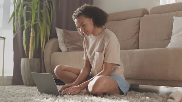 Biracial Girl Using Laptop at Home