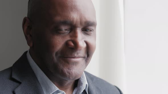 Portrait of African Mature Middle Aged Businessman Afro Black Male Wrinkled Face Standing in Office