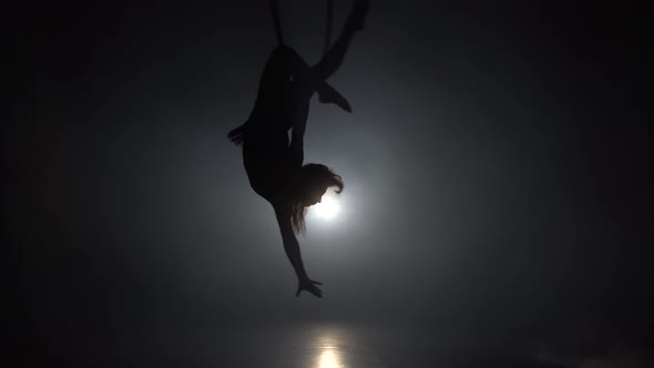 Aerial Acrobat in the Ring. A Young Girl Performs the Acrobatic Elements in the Air Ring