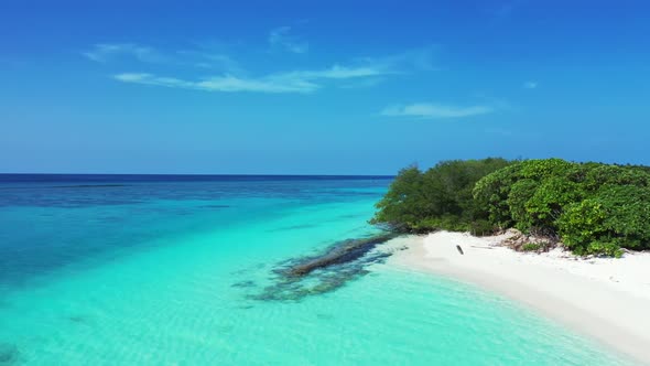 Aerial drone seascape of marine coastline beach voyage by blue lagoon and white sandy background of 