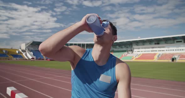 Sportsman Drinking Water During Training