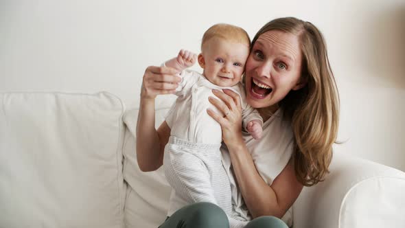 Joyful Excited Mom Holding Cute Baby