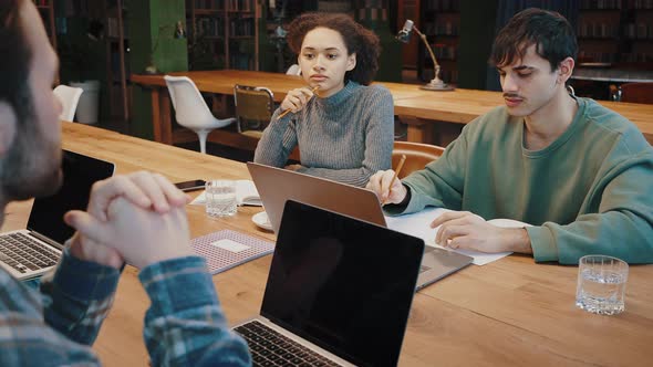 Diverse Mixed Race Students Prepare for Examination Together at Library