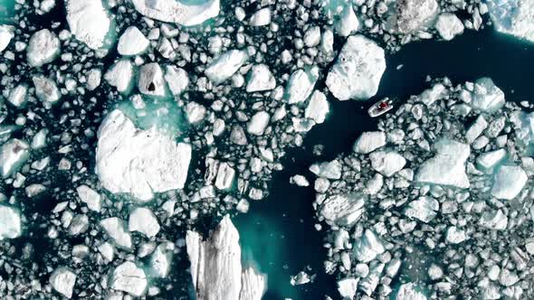 Boat In The Middle Of Melting Iceberg In Alaska, USA. - Aerial Descending Shot