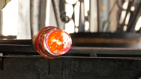 Glassworks glass manufacturing process - glass rolling on the marver