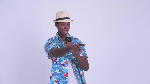 Young Happy African Tourist Man Singing with Microphone