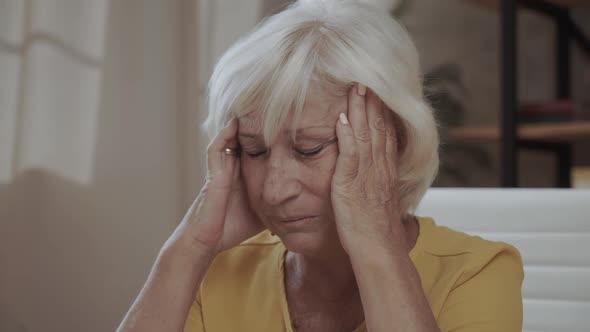 Health Care Pain Stress Age and People Concept  Face of Senior Woman Suffering From Headache