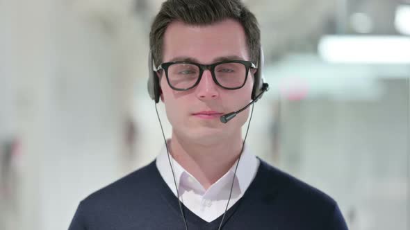 Young Businessman with Headset Looking at the Camera