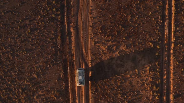 Aerial View Off Road 4X4 Car Driving Along Dirt Road Among the Desert