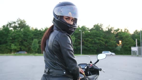 Woman in Protective Helmet Posing on Camera on Luxurious Motorbike Before Start to Ride