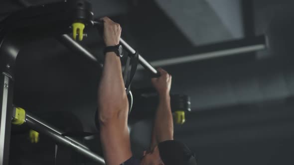 Disabled Athlete in Wheelchair Performs Pullups on the Horizontal Bar Gym Training People with