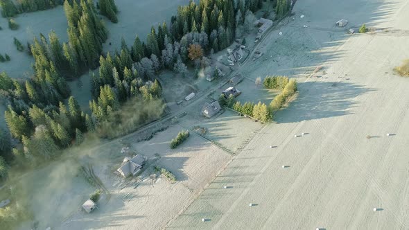 Poland countryside with several farmstead next to grassland at dawn, aerial
