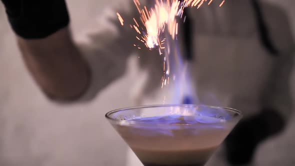 Bartender Strew Cinnamon Powder to Flame of Cocktail