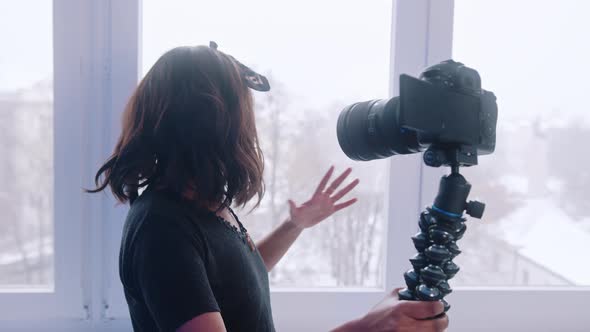 Cheerful Woman Blogger Holding Camera and Recording Video for Vlog While Standing Near the Window