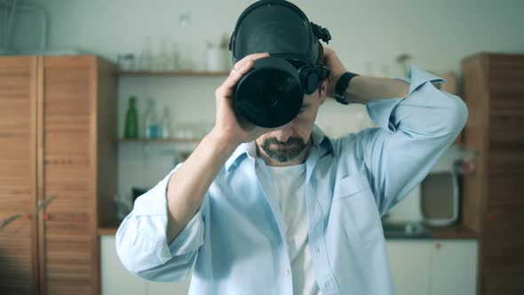 Adult Man Is Putting on a Hazmat Mask While Being at Home During Pandemic of Coronavirus, Covid-19.