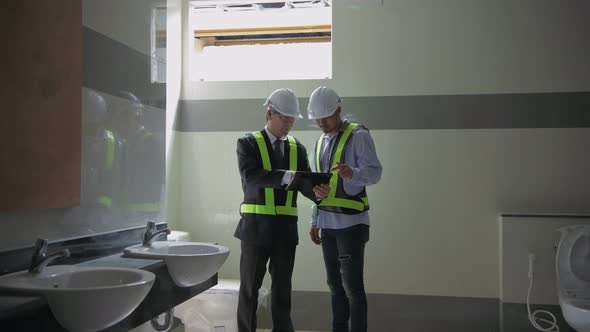 Engineer concept. The architect is examining the construction of the toilets, 4k Resolution