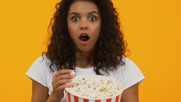 Young Pretty Female Eating Pop Corn, Watching Exciting Movie in Cinema, Hobby