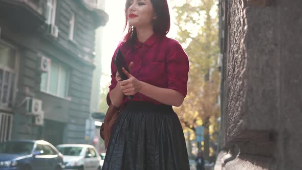 Stylish Woman Using Tablet Pc in the Street