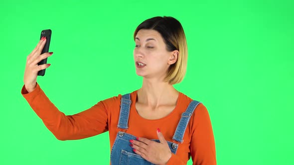 Girl Talking for Video Chat Using Mobile Phone. Green Screen