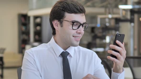 Businessman Excited for Success on Smartphone