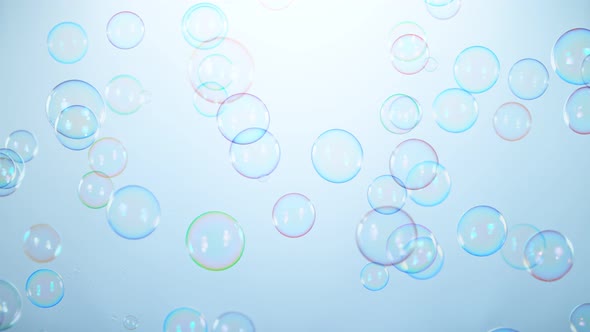 Super Slow Motion Shot of Flying Colorful Soap Bubbles on Light Blue Background at 1000 Fps