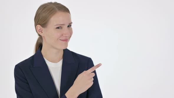 Young Businesswoman Pointing Towards Product on White Background