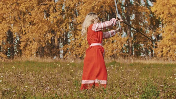 Medieval Concept - Woman in Red National Dress on the Field Masterfully Wields Swords - Rotating