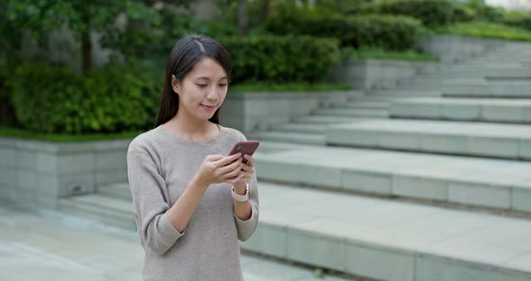 Woman use of smart phone in city