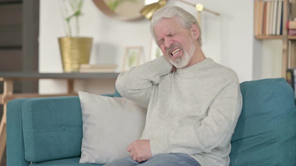 Exhausted Old Man Having Neck Pain on Sofa 