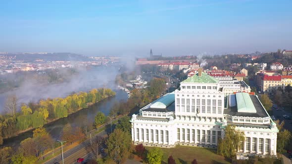 A huge spring evaporation of Vltava river in haze,Prague city,Czechia,aerial view.