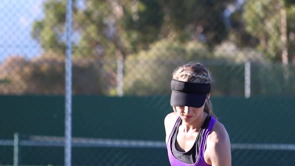 Close up footage of a female tennis player playing tennis on a tennis court