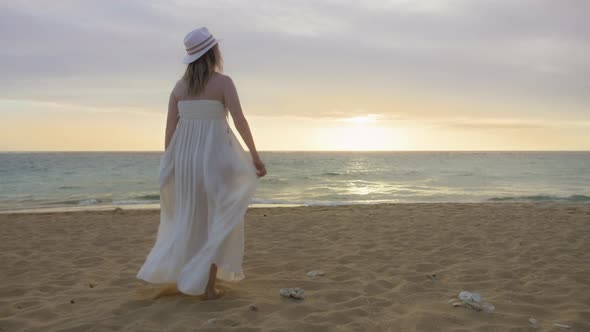 People on Ocean Beach Happy Female Silhouette Walking at Golden Sunset Hawaii
