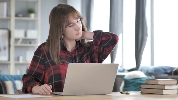 Casual Young Girl with Neck Pain Working on Laptop